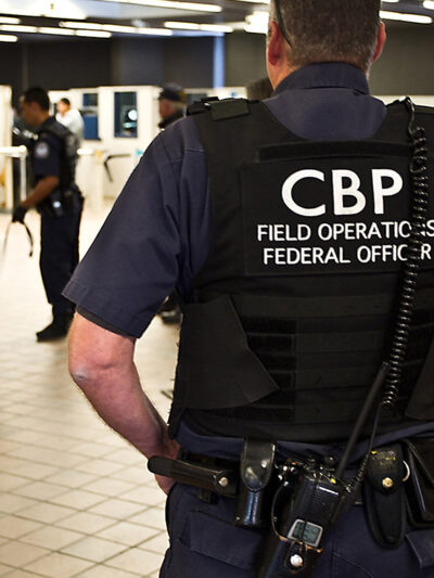 CBP officer watching pedestrian entrance