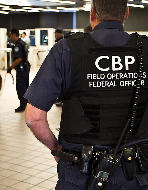 CBP officer watching pedestrian entrance