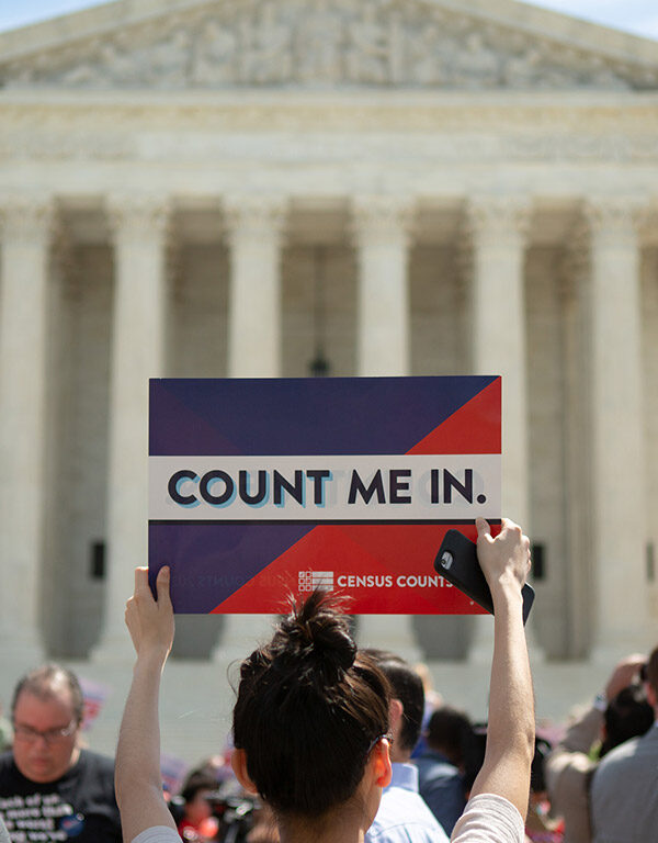Demonstrators marching against adding a question regarding citizenship to the Census