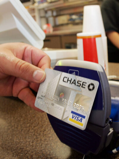 A customer uses a contactless credit card at a card reader