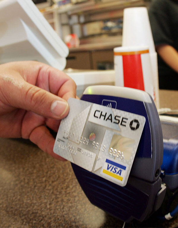 A customer uses a contactless credit card at a card reader
