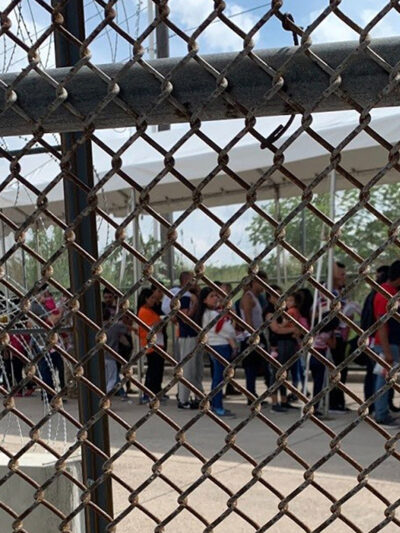Families at the border through fence