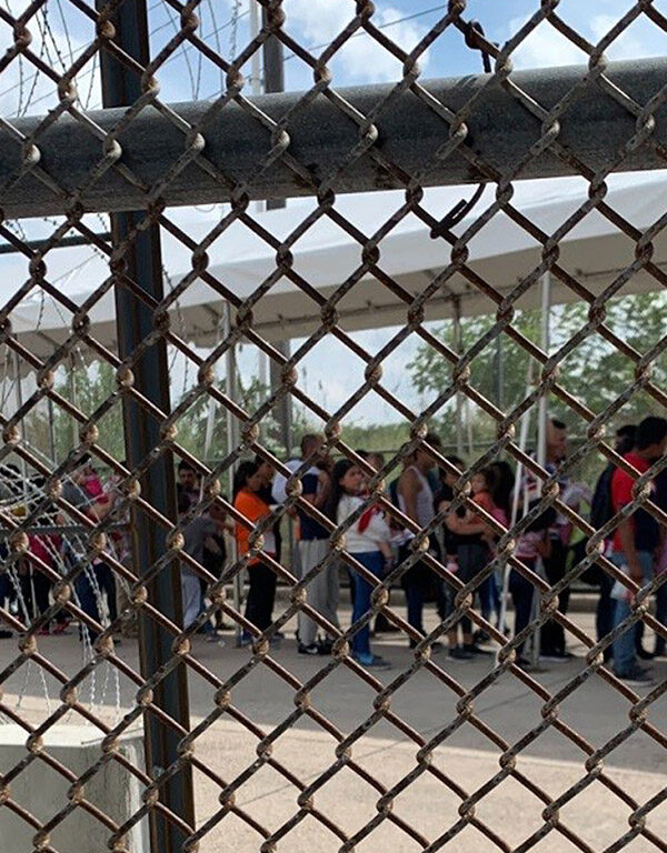 Families at the border through fence