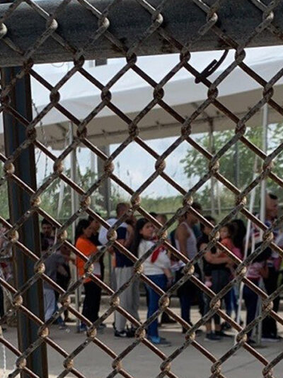 Families at the border through fence