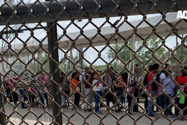 Families at the border through fence