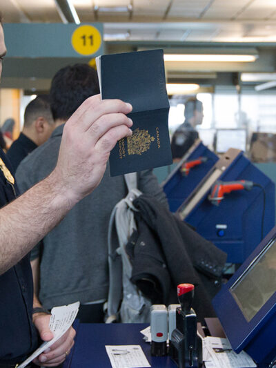A CBP agent inspecting a passport