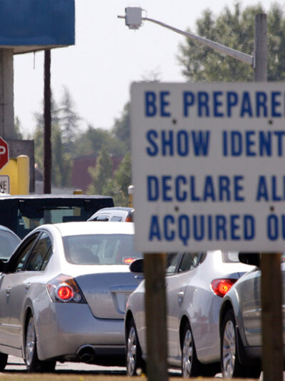 A line of cars wait to enter the United States from Canada in Blaine, Wash.