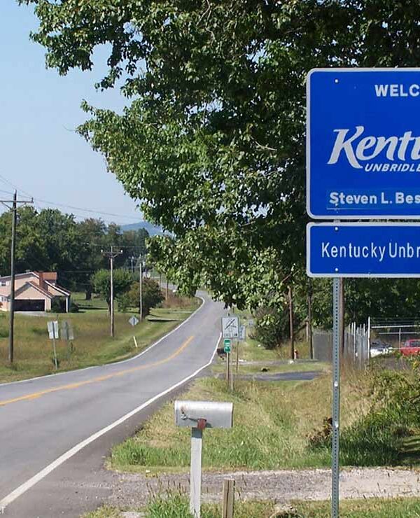 A Welcome to Kentucky road sign with the name of Governor Steven L. Beshear