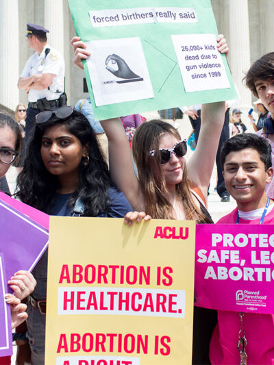 Pro-choice demonstrators with signs advocating the protection of the right to a safe abortion and that abortion is healthcare.