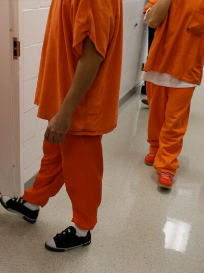 Detainees walk in a hallway at the Northwest Detention Center, a federal immigration facility in Tacoma, Washington.