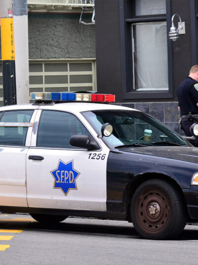 White SFPD officers interrogating Black men in San Francisco.