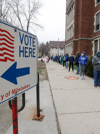 Voters line up outside of a polling station in Milwaukee for Wisconsin's primary election.