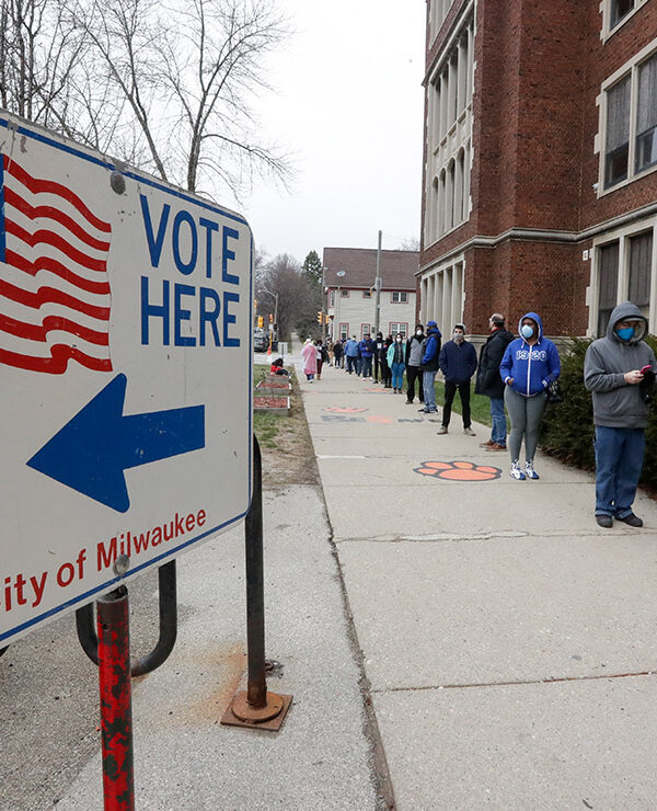 Voters line up outside of a polling station in Milwaukee for Wisconsin's primary election.