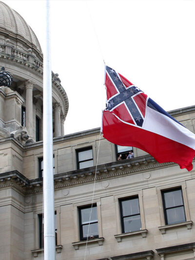 The retired Mississippi state flag is raised over the Capitol grounds one final time in Jackson, Mississippi
