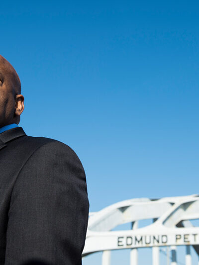 Rep. John Lewis stands on the Edmund Pettus Bridge in Selma, Alabama. The late representative was beaten by police on the bridge on "Bloody Sunday" on March 7, 1965.