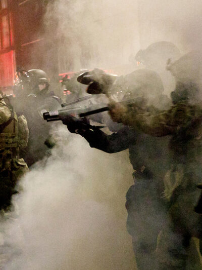 Federal officers open fire on demonstrators with 'less-lethal' weapons, as demonstrators protest against police brutality.