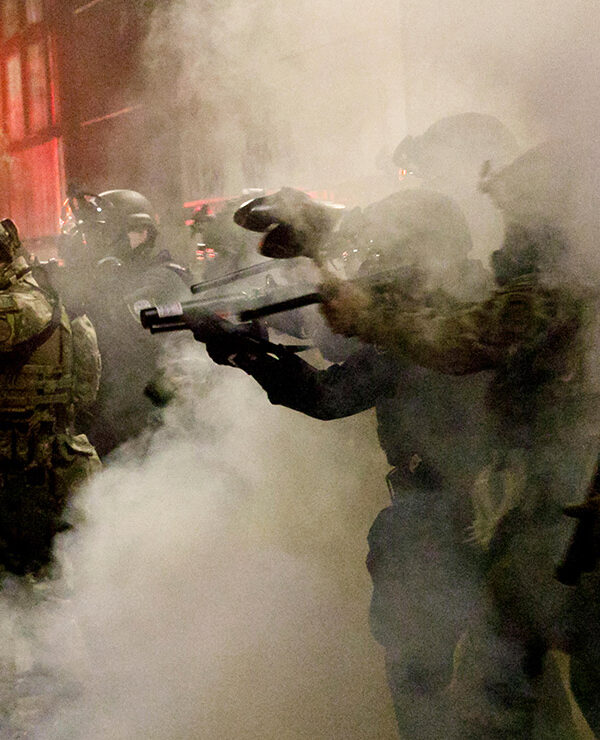 Federal officers open fire on demonstrators with 'less-lethal' weapons, as demonstrators protest against police brutality.