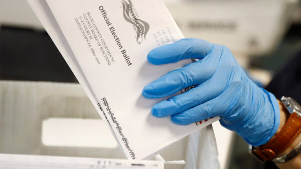 A worker processes mail-in ballots.