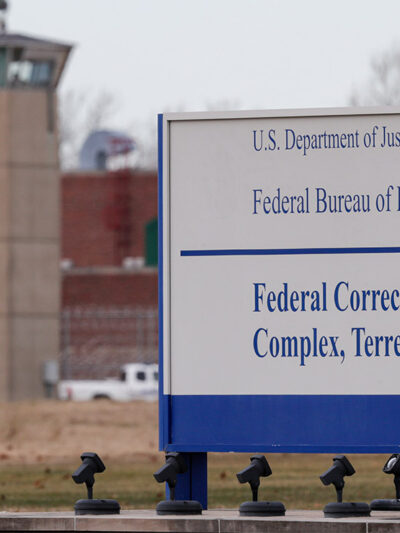 A guard tower flanks the sign at the entrance to the U.S. Penitentiary in Terre Haute.