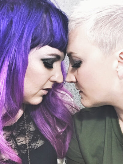A same-sex relationship runs ad on Facebook of two women leaning foreheads against each other, and finds that the ad is removed by the social media platform.