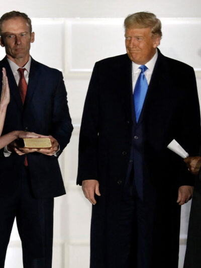 U.S. President Donald Trump smiles as Judge Amy Coney Barrett is sworn in as the Supreme Court associate justice by Justice Clarence Thomas on South Lawn of White House.
