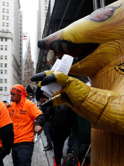 A giant inflatable rat stands in front of a non-union worksite where union workers protested during a May Day rally