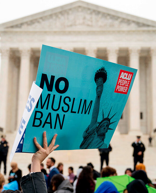 A person holds up a sign that reads "No Muslim Ban" during an anti-Muslim ban rally at the Supreme Court.