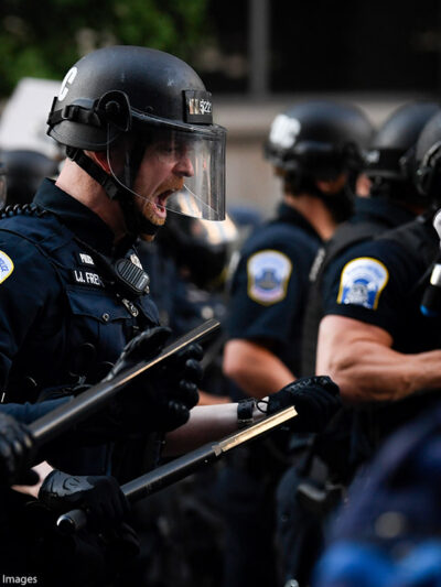 Police in riot gear shouts in black protestor's face as demonstrators gather to protest the death of George Floyd near the White House