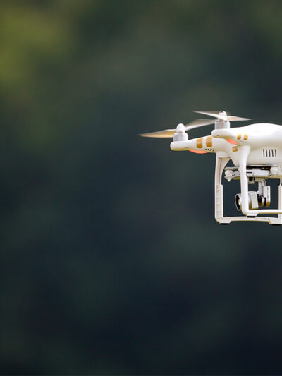 A civilian UAV, or drone, flying outdoors.