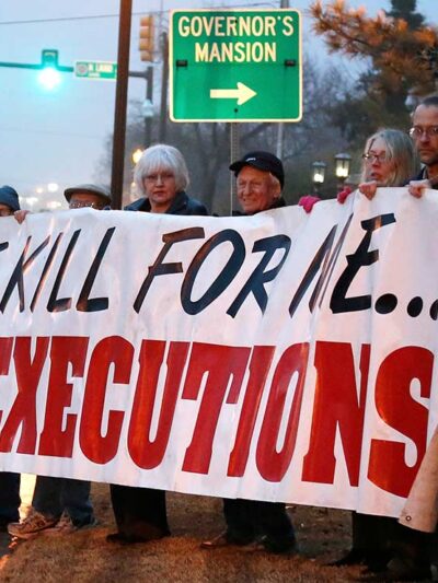 Protestors holding a banner with the text "Don't kill for me...Stop executions."