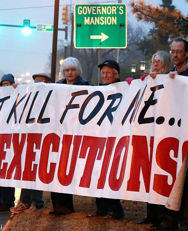 Protestors holding a banner with the text "Don't kill for me...Stop executions."