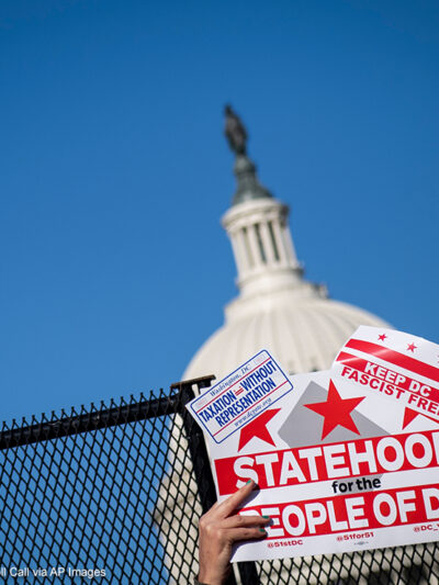 A demonstrator holds up a sign advocating for statehood for Washington, D.C.