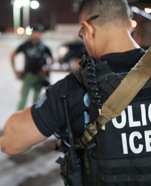The back of a police vest reads "Police ICE"