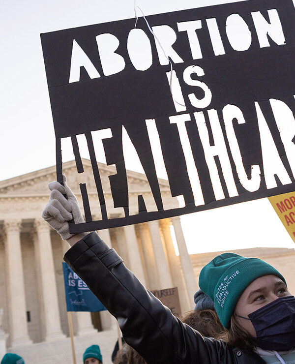 A person at a rally holding a sign that says “Abortion is Healthcare.”