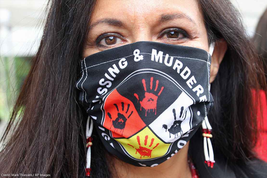 Jeannie Hovland, the deputy assistant secretary for Native American Affairs for the U.S. Department of Health and Human Services, poses with a Missing and Murdered Indigenous Women mask.
