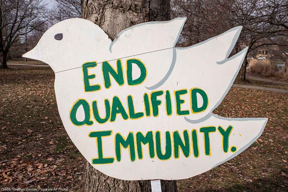 Sign of white dove reading "End Qualified Immunity", Qualified Immunity gives police officers immunity in the court of law given certain circumstances.