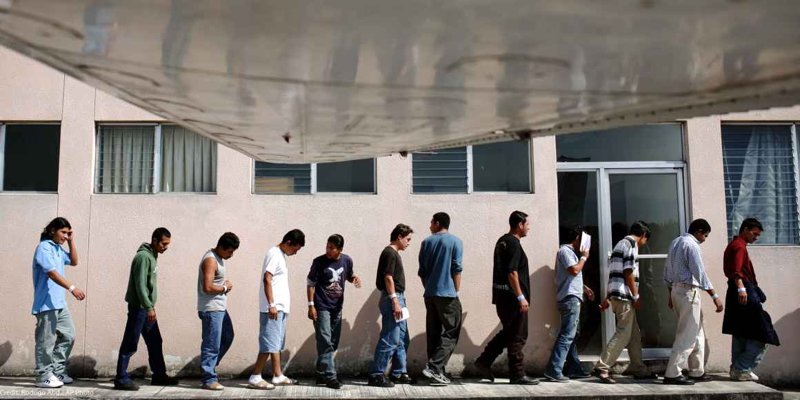 A line of Guatemalans arriving outside of the Guatemala City airport after having been deported from the US back to Guatemala.