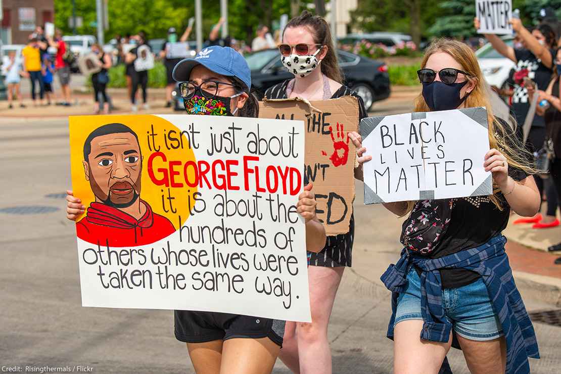 BLM protester holding a sign that says, "It isn't just about George Floyd it is about the hundreds of others whose lives were taken the same way."