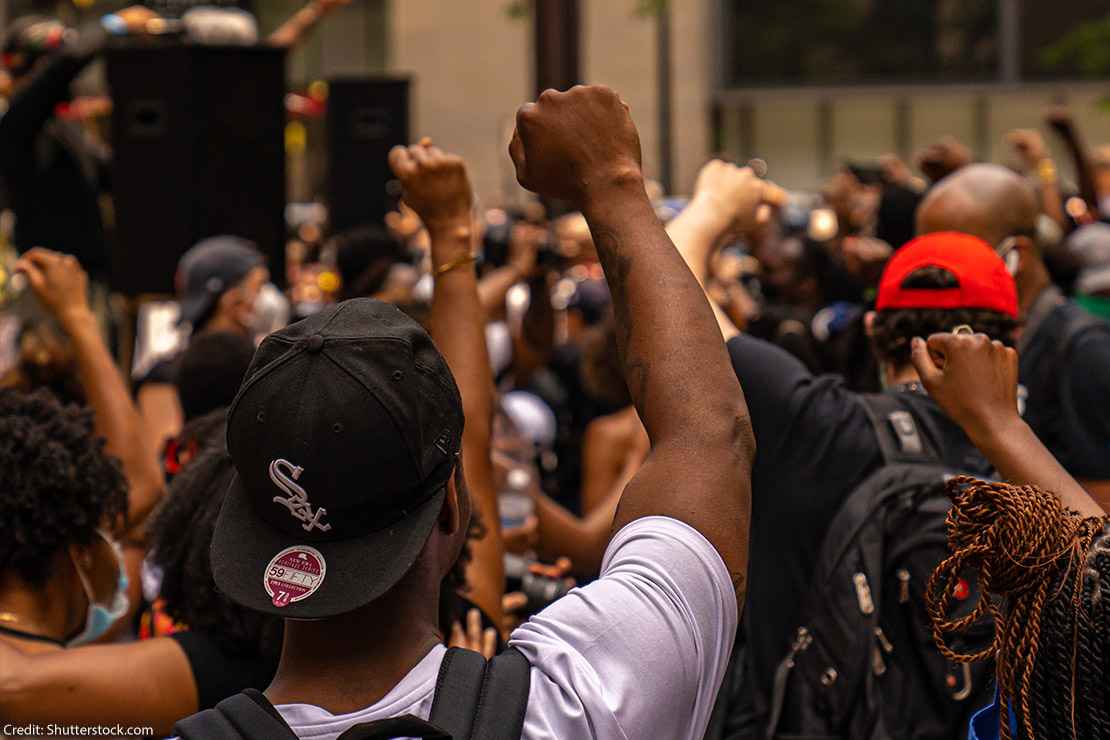 Black man raises fist in the air during a Juneteenth Rally in Chicago