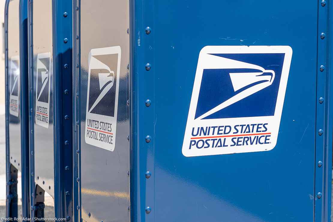 A blue United States Postal Service (USPS) collection box as seen on the street.