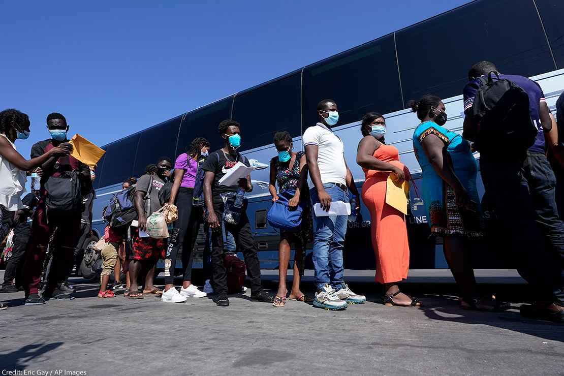 Migrants, many from Haiti, board a bus after they were processed and released after spending time at a makeshift camp near the International Bridge, Monday, Sept. 20, 2021, in Del Rio, Texas.