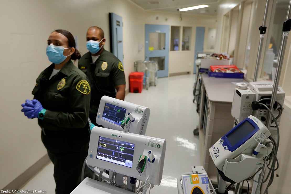 Custody assistants walking through hallway of the hospital ward in a jail in Los Angeles.