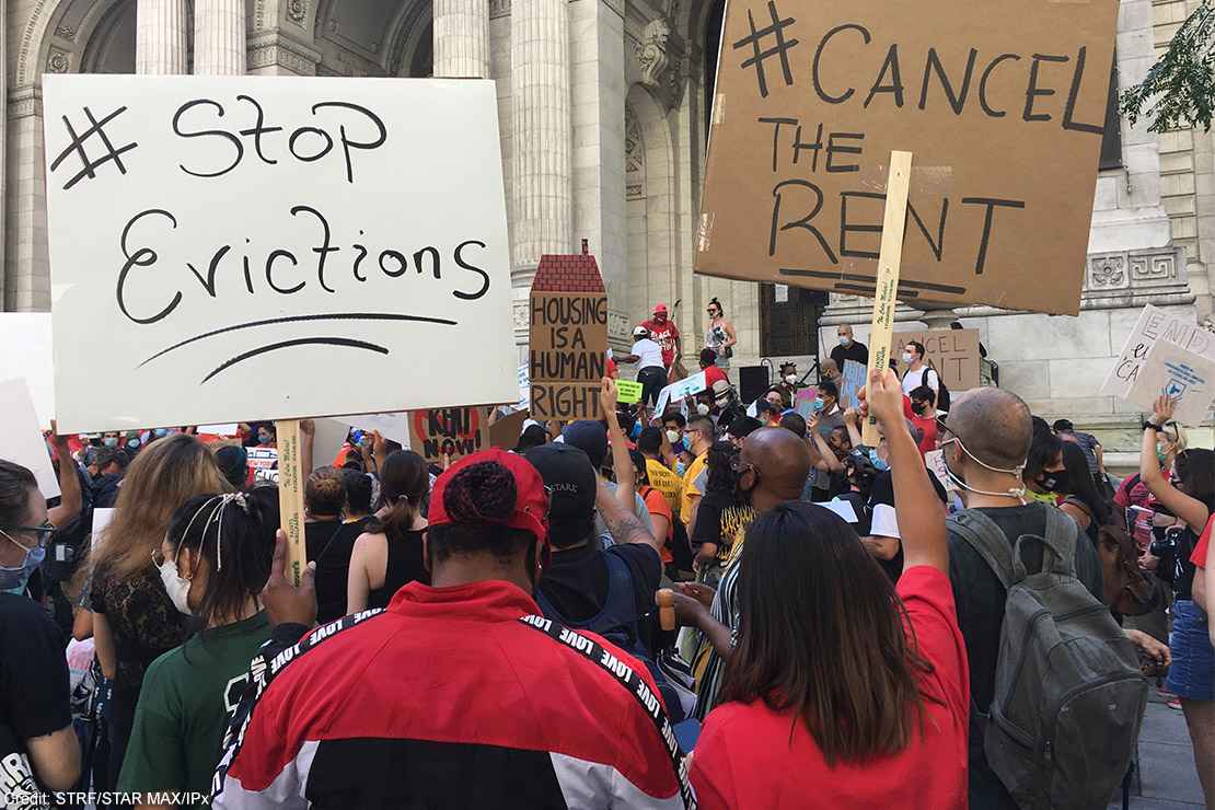 Protesters demonstrating with signs calling for rent relief and an end to evictions.