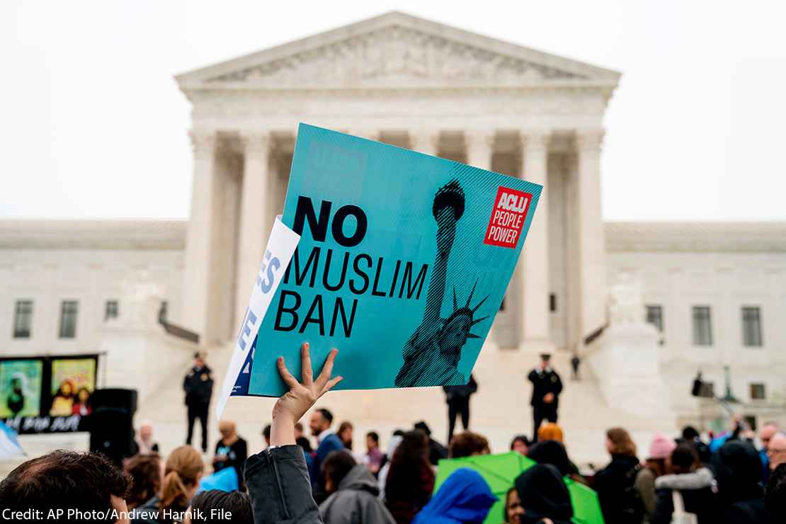 In this April 25, 2018 file photo, a person holds up a sign that reads "No Muslim Ban" during an anti-Muslim ban rally in front of the Supreme Court building in Washington, DC.