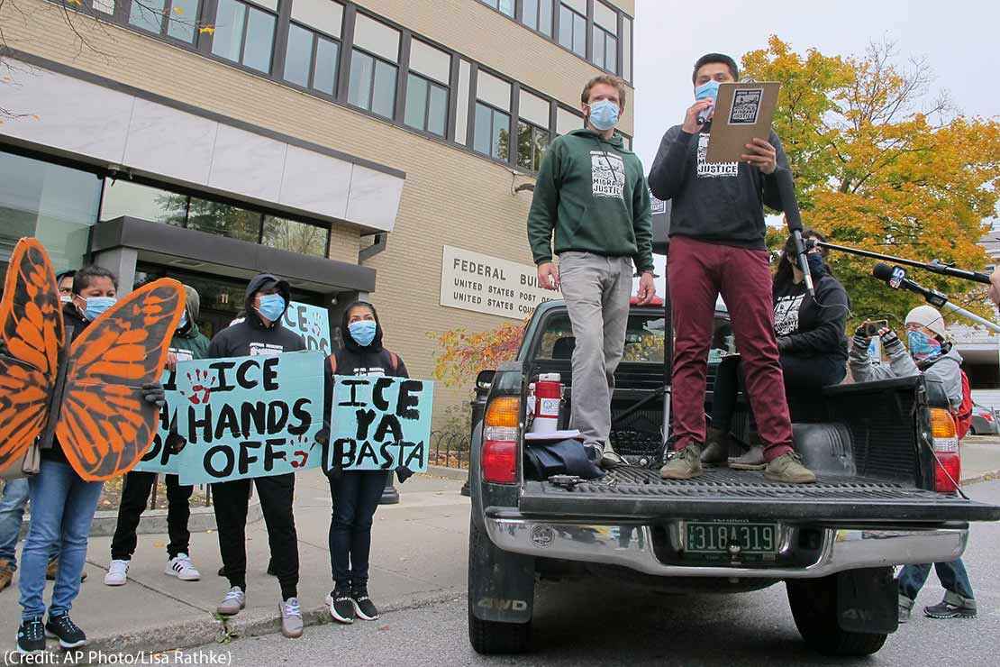 Enrique Balcazar, of Migrant Justice, an advocacy group representing immigrant farmworkers in Vermont, speaks to a crowd outside the federal court in Burlington, Vt.