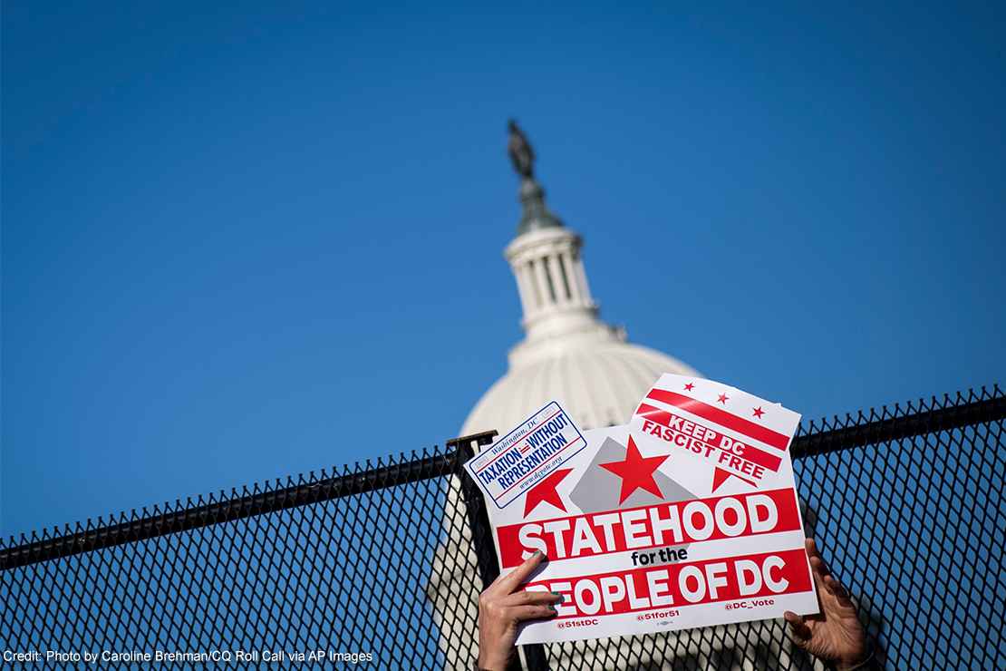 A demonstrator holds up a sign advocating for statehood for Washington, D.C.