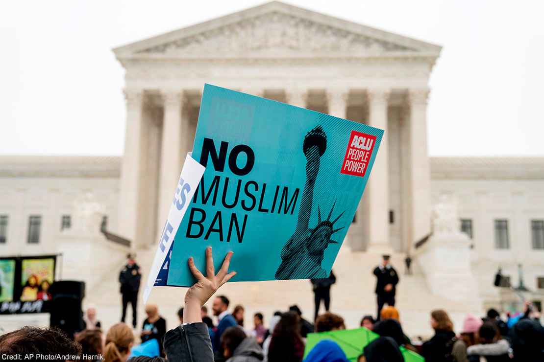 A person holds up a sign that reads "No Muslim Ban" during an anti-Muslim ban rally at the Supreme Court.