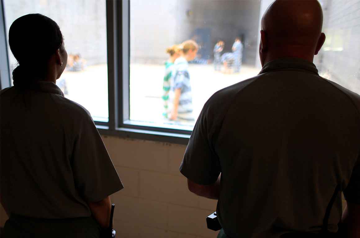 Deputies observe incarcerated people at in a women&#039;s detention area