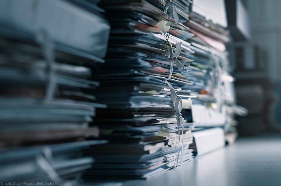 Stacks of files in a dark office