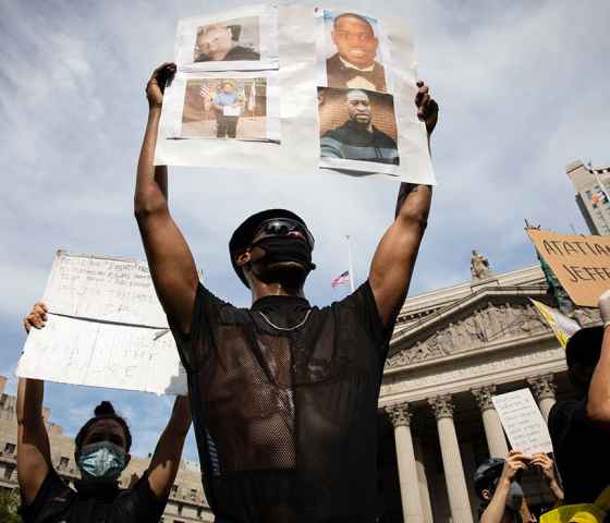 A protester holds up a sign with picutres of Black Americans who have been killed by police, taken in New York City June 2, 2020